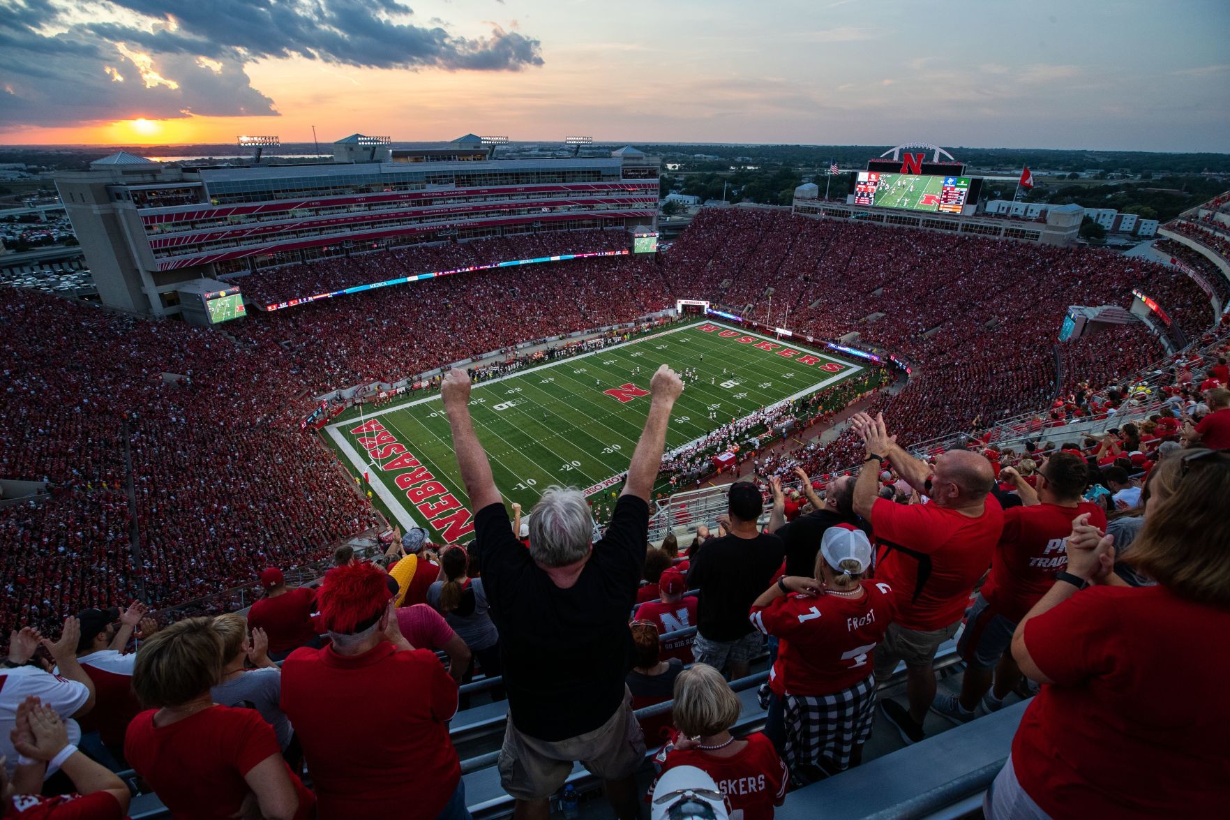 Jim Linafelter of Sergeant Bluff, Iowa, and other Husker fans celebrate a third-down stop for Nebraska’s defense against Northern Illinois.